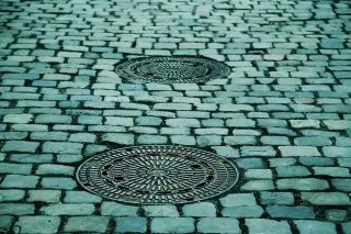 Cobblestone Street with Manholes