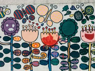 A painting of flowers and butterflies on a wall